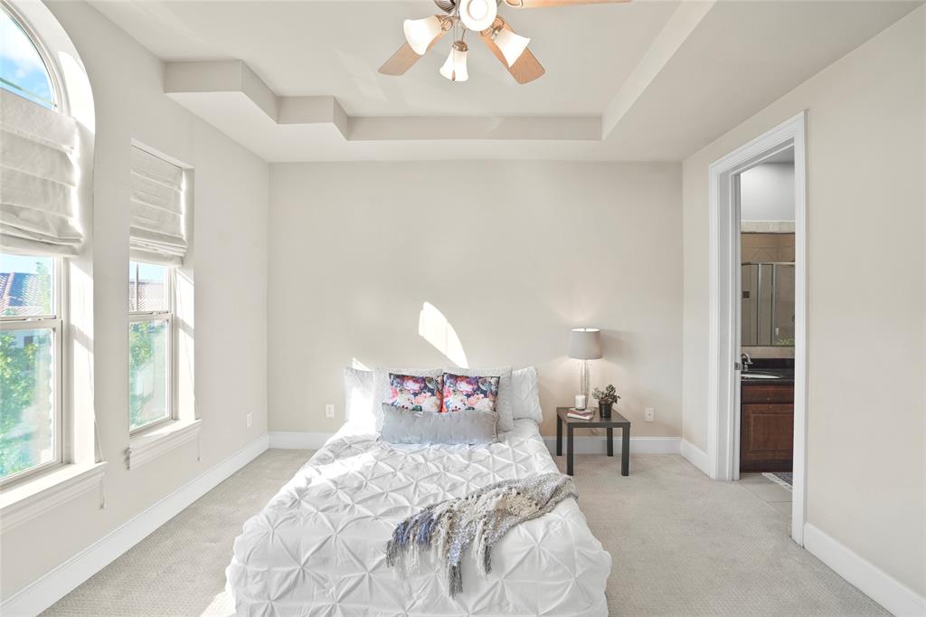 6748 Plaza Via Irving, TX 75039 - Photo 13 of 31 a bedroom with a bed and a chandelier