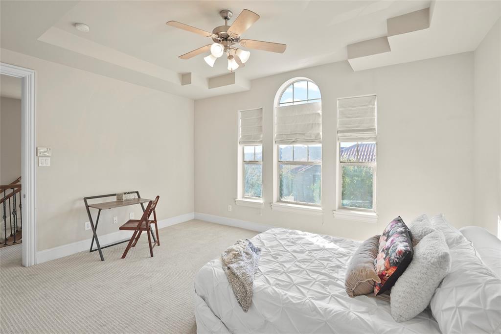 6748 Plaza Via Irving, TX 75039 - Photo 14 of 31 a bedroom with a bed and a chandelier