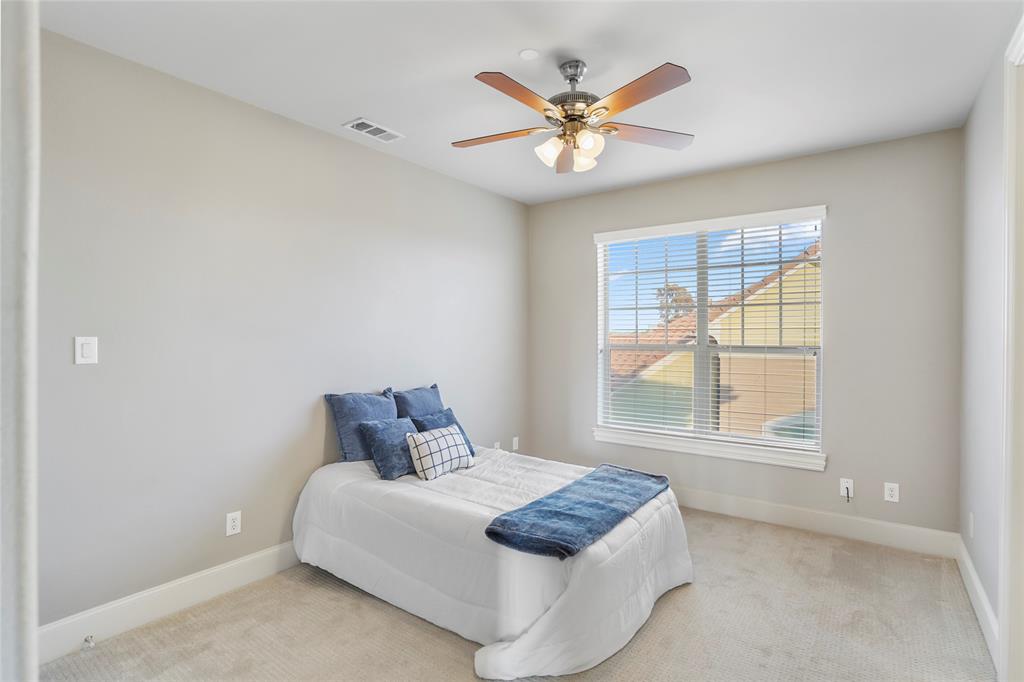 6748 Plaza Via Irving, TX 75039 - Photo 18 of 31 a bedroom with a large bed and a window
