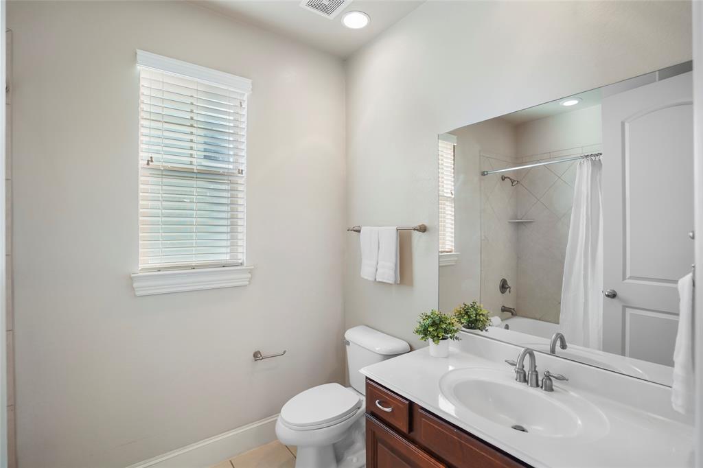 6748 Plaza Via Irving, TX 75039 - Photo 21 of 31 a bathroom with a sink a toilet and shower