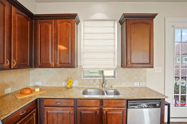 a kitchen with stainless steel appliances granite countertop a sink stove and cabinets