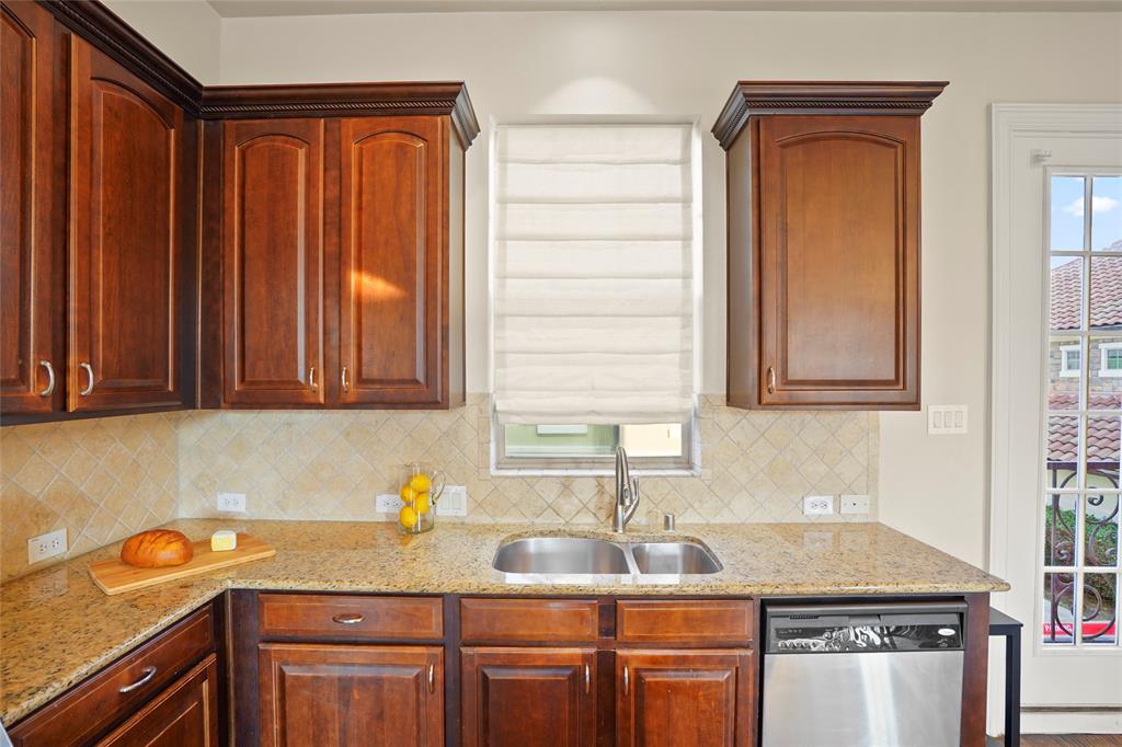 6748 Plaza Via Irving, TX 75039 - Photo 8 of 31 a kitchen with stainless steel appliances granite countertop a sink stove and cabinets