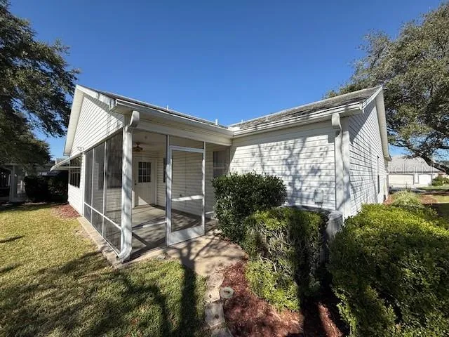 a view of house with backyard and sitting area
