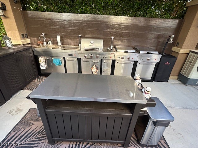 8175 Arville Street, Unit 210 Las Vegas, NV 89139 - Photo 12 of 36 View of patio featuring outdoor dining space and an outdoor kitchen