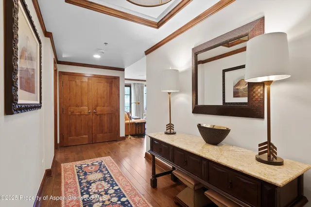 a hallway with a table and chair