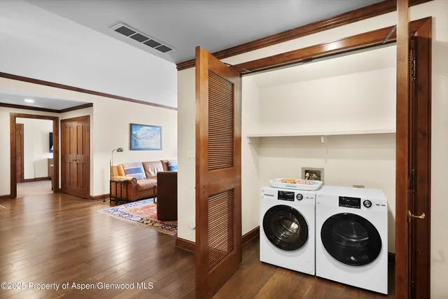 a view of a hallway with washer and dryer