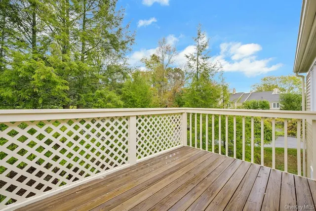 a view of a balcony with wooden floor