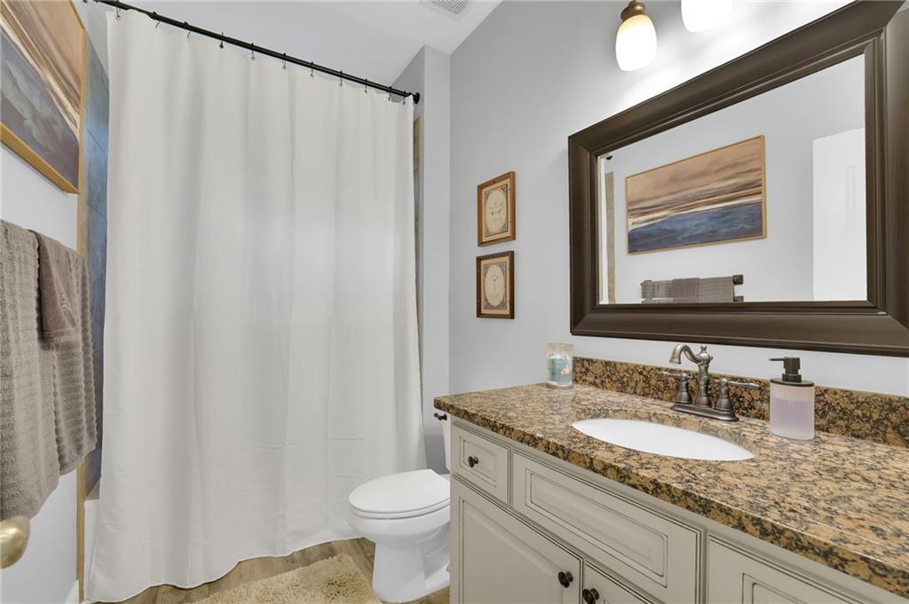 6010 Anchorage Quay Cumming, GA 30041 - Photo 12 of 72 a bathroom with a granite countertop sink and a mirror