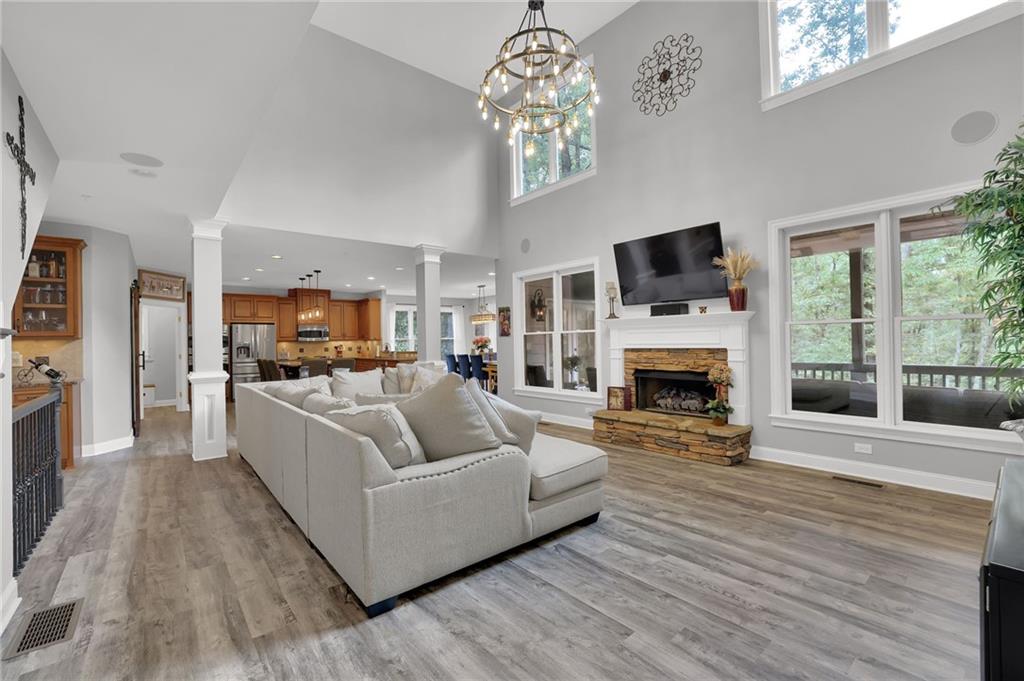 6010 Anchorage Quay Cumming, GA 30041 - Photo 13 of 72 a living room with furniture a fireplace and a flat screen tv