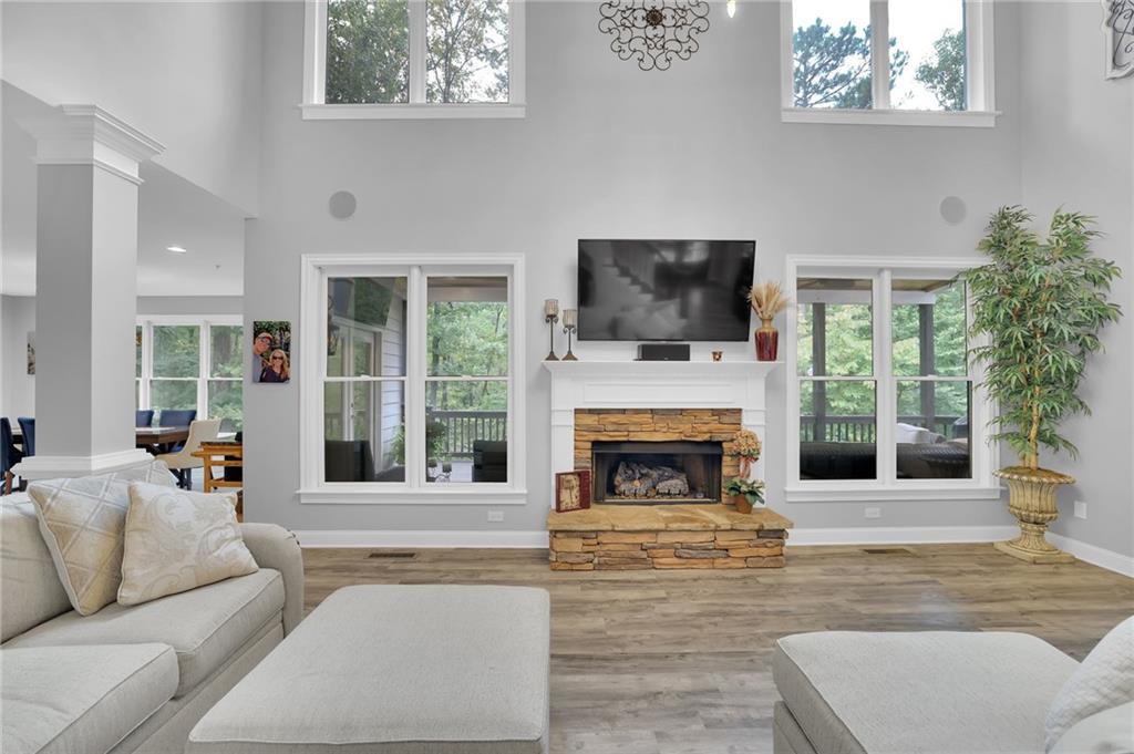 6010 Anchorage Quay Cumming, GA 30041 - Photo 14 of 72 a living room with furniture a flat screen tv and a fireplace