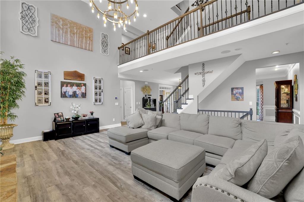6010 Anchorage Quay Cumming, GA 30041 - Photo 15 of 72 a living room with furniture and a chandelier