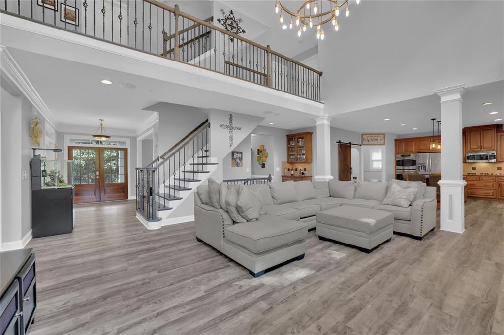 6010 Anchorage Quay Cumming, GA 30041 - Photo 18 of 72 a living room with furniture and a chandelier