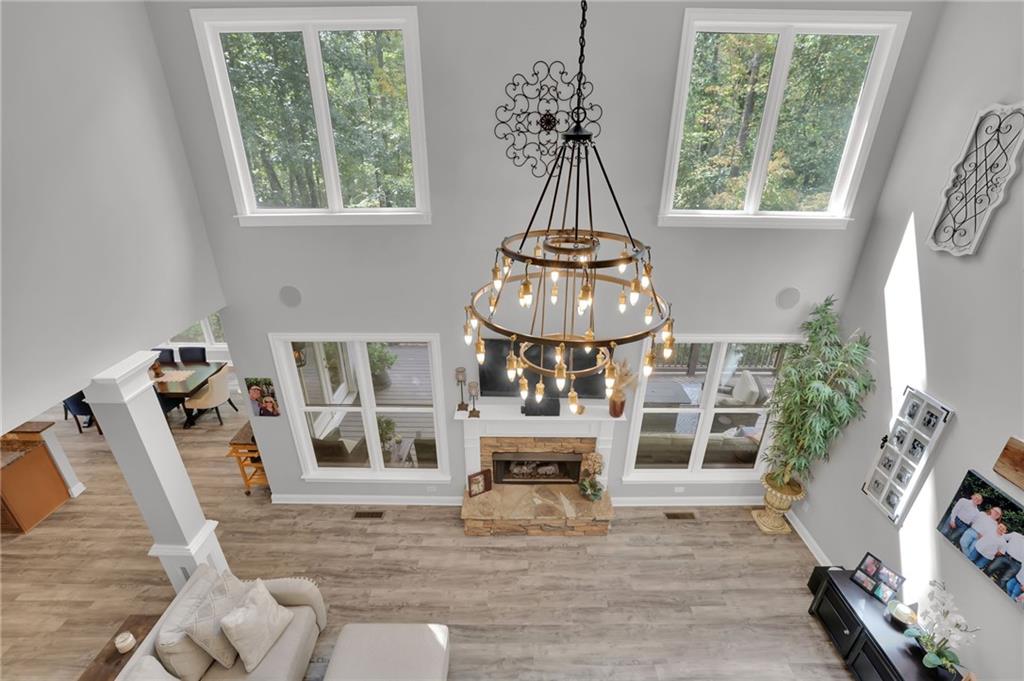 6010 Anchorage Quay Cumming, GA 30041 - Photo 19 of 72 a view of a livingroom with furniture wooden floor windows and a chandelier