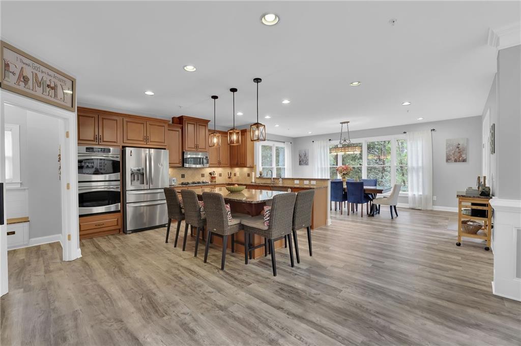 6010 Anchorage Quay Cumming, GA 30041 - Photo 20 of 72 a view of a dining room kitchen with furniture and wooden floor