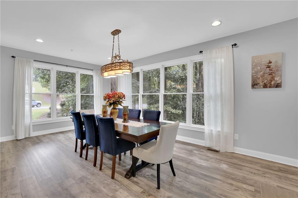 6010 Anchorage Quay Cumming, GA 30041 - Photo 29 of 72 a dining room with furniture window wooden floor