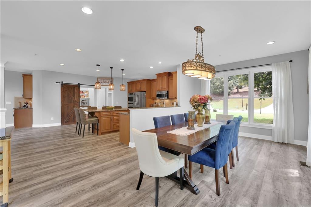 6010 Anchorage Quay Cumming, GA 30041 - Photo 30 of 72 a view of a dining room and livingroom with furniture wooden floor a chandelier