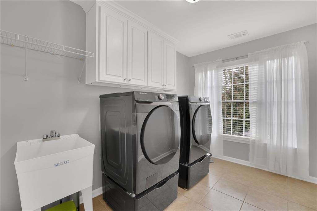 6010 Anchorage Quay Cumming, GA 30041 - Photo 34 of 72 a utility room with dryer and washer