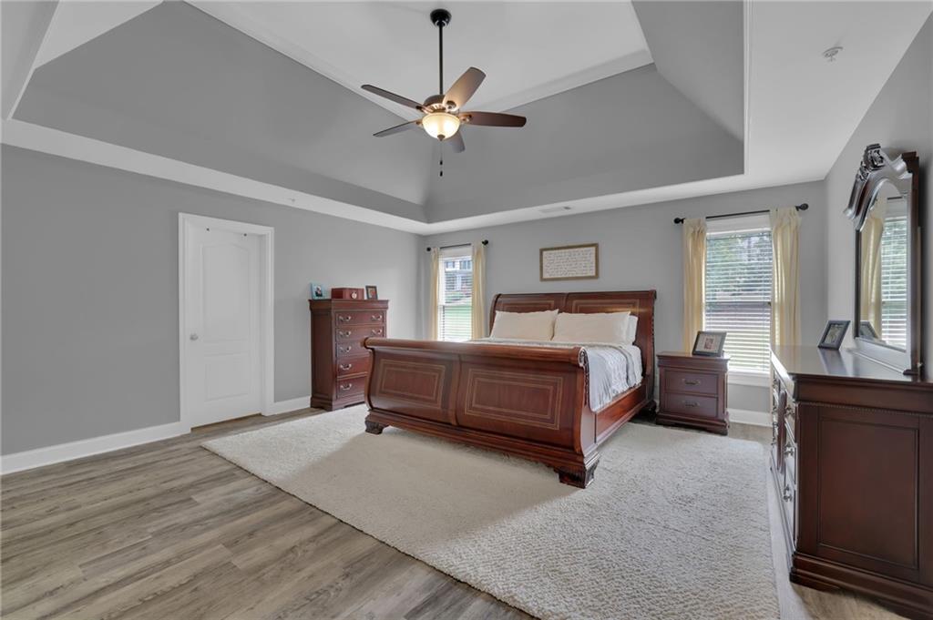 6010 Anchorage Quay Cumming, GA 30041 - Photo 35 of 72 a bedroom with a bed and ceiling fan