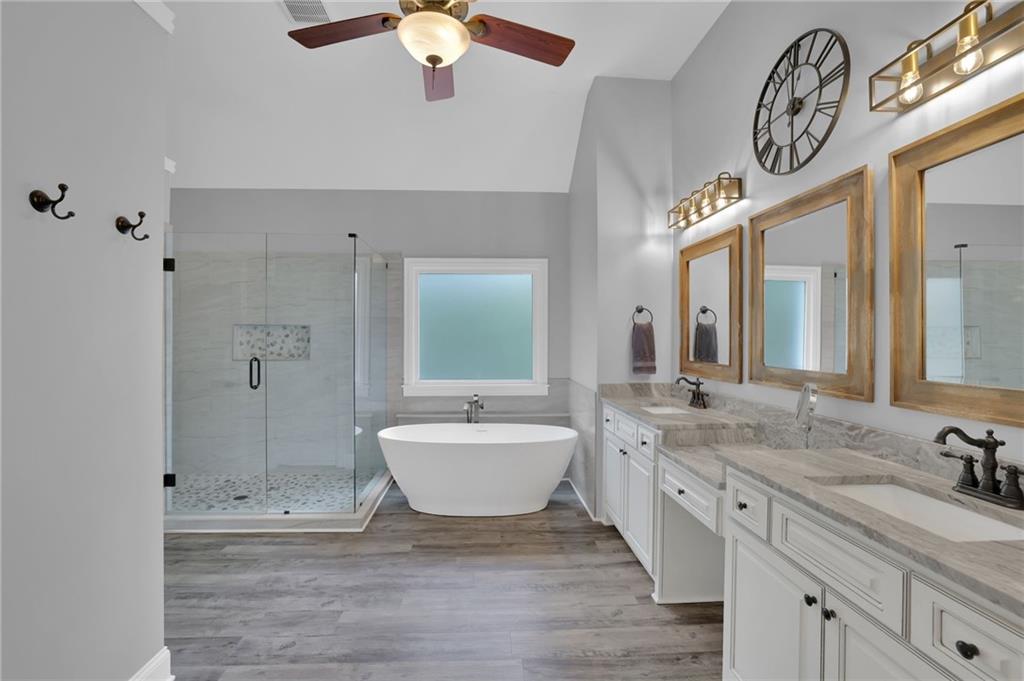 6010 Anchorage Quay Cumming, GA 30041 - Photo 37 of 72 a spacious bathroom with a granite countertop sink mirror and bathtub