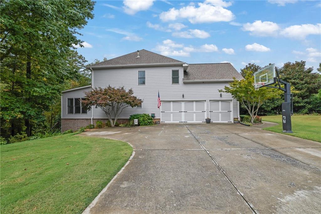 6010 Anchorage Quay Cumming, GA 30041 - Photo 4 of 72 a front view of a house with a yard and garage