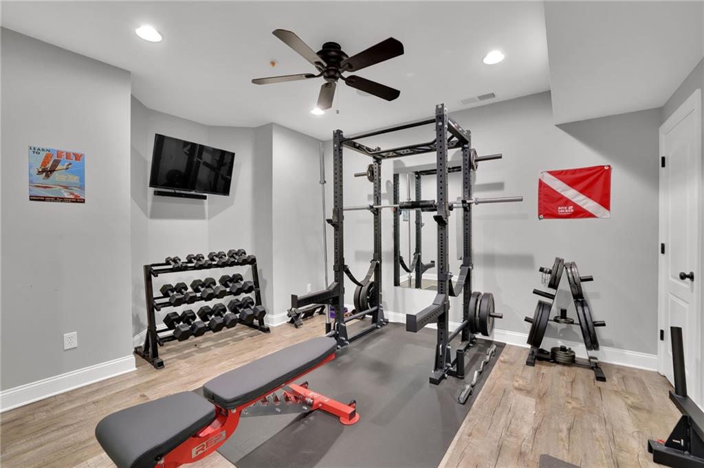 6010 Anchorage Quay Cumming, GA 30041 - Photo 51 of 72 a room with gym equipment and a flat screen tv