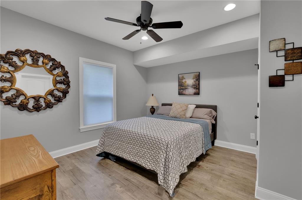 6010 Anchorage Quay Cumming, GA 30041 - Photo 53 of 72 a bedroom with a bed and a chandelier
