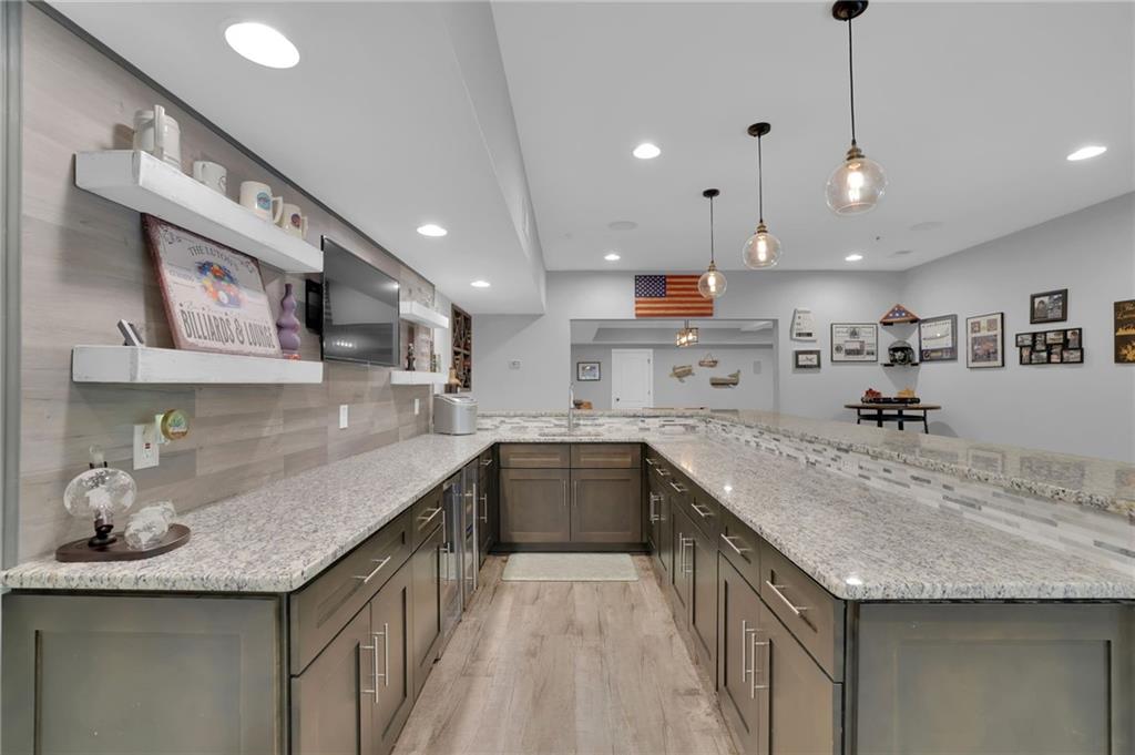 6010 Anchorage Quay Cumming, GA 30041 - Photo 56 of 72 a kitchen with stainless steel appliances granite countertop a sink and stove
