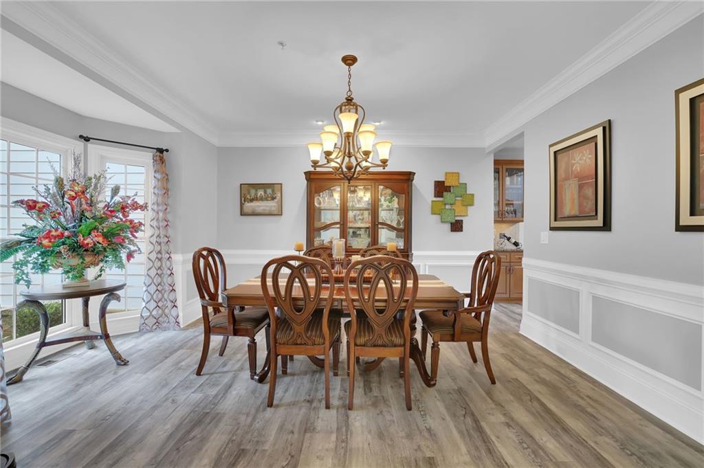 6010 Anchorage Quay Cumming, GA 30041 - Photo 8 of 72 a view of a dining room with furniture window and wooden floor