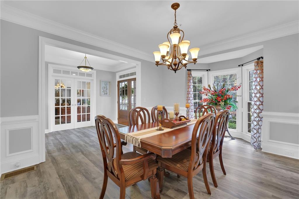 6010 Anchorage Quay Cumming, GA 30041 - Photo 10 of 72 a view of a dining room with furniture wooden floor and chandelier