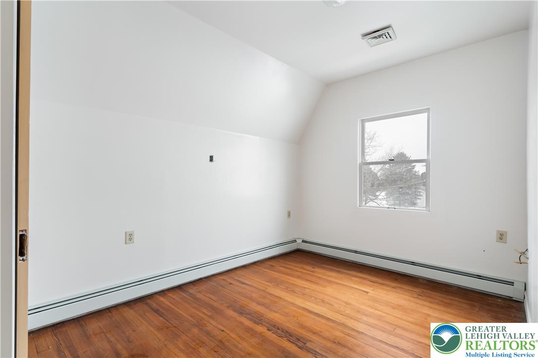 384 Evansville Road Fleetwood, PA 19522 - Photo 24 of 54 an empty room with wooden floor and windows