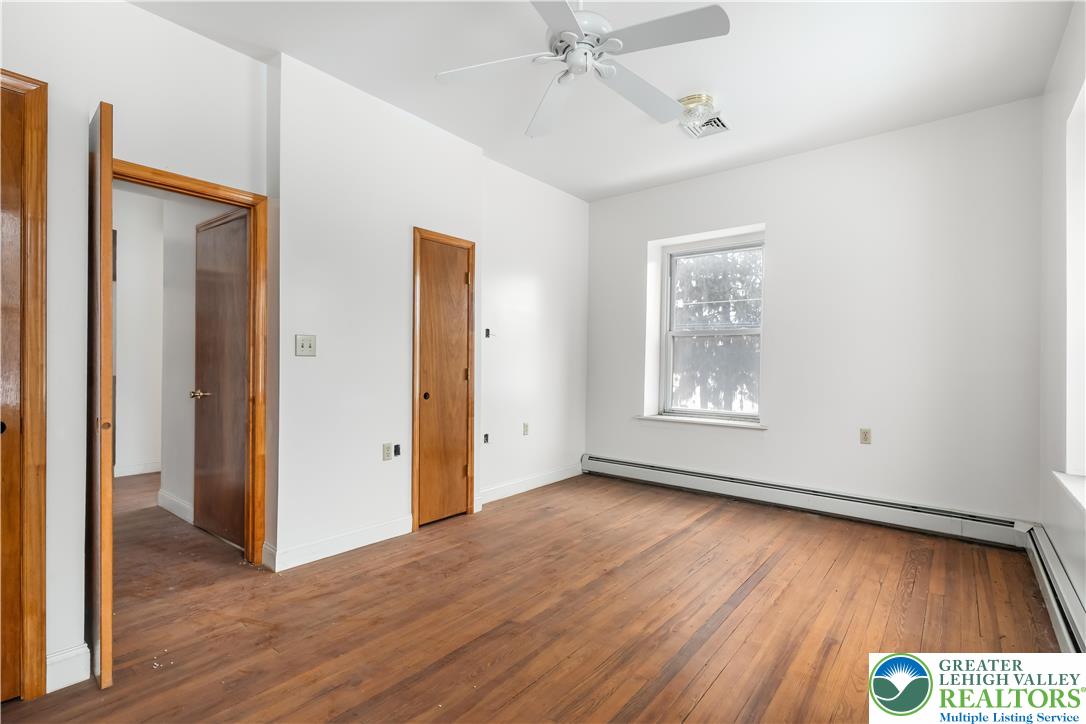 384 Evansville Road Fleetwood, PA 19522 - Photo 25 of 54 a view of an empty room with wooden floor and a window