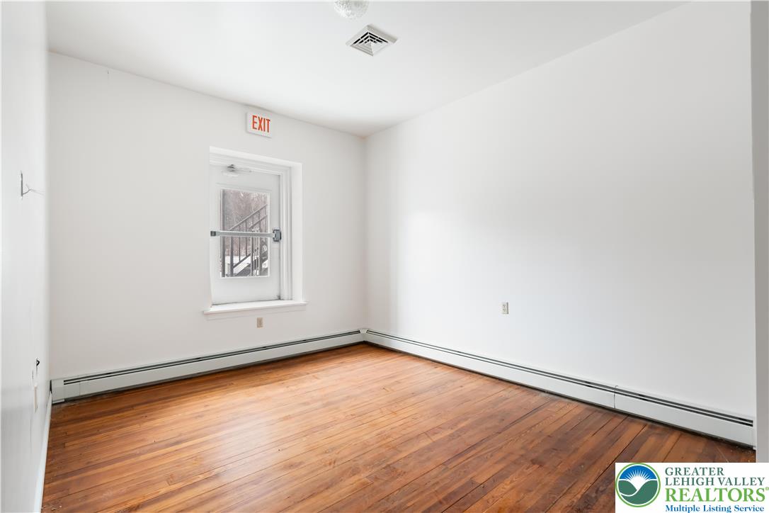 384 Evansville Road Fleetwood, PA 19522 - Photo 29 of 54 a view of an empty room with wooden floor and a window