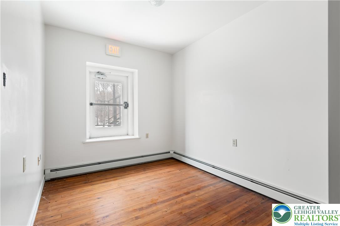 384 Evansville Road Fleetwood, PA 19522 - Photo 31 of 54 an empty room with wooden floor and windows