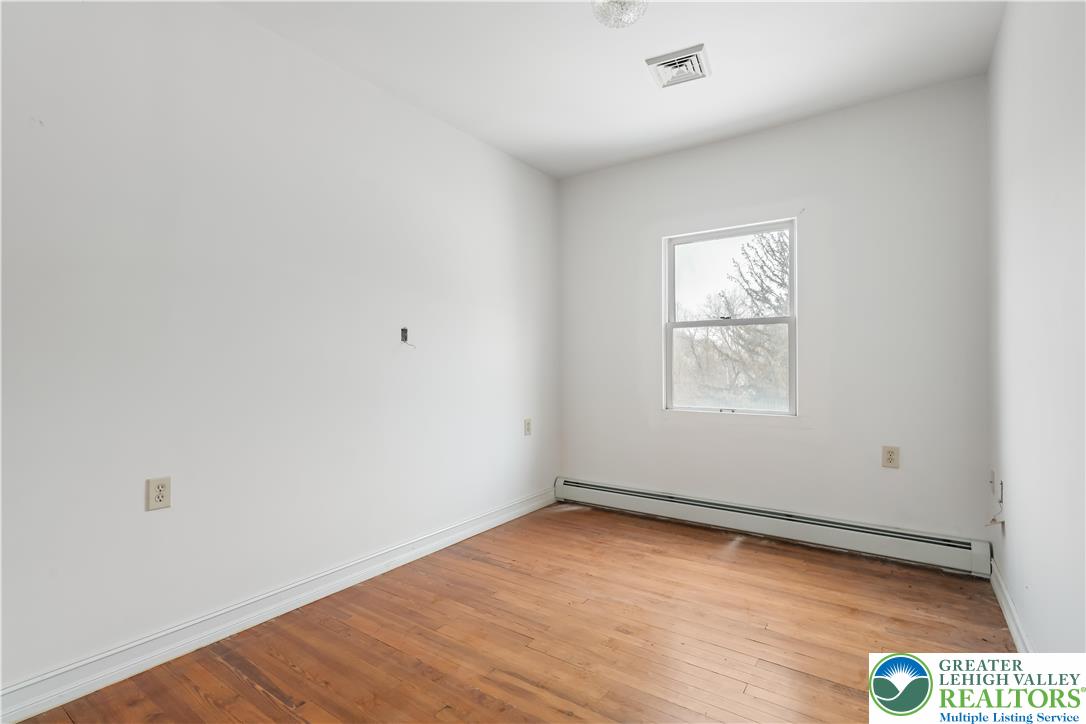 384 Evansville Road Fleetwood, PA 19522 - Photo 37 of 54 an empty room with wooden floor and windows