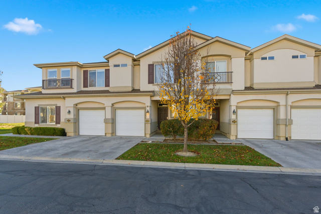 202 Alpine Trail Drive Draper, UT 84020 - Photo 1 of 1 View of front of property with stucco siding, a balcony, driveway, and an attached garage