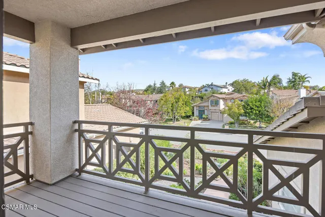 a view of a balcony with furniture and a potted plant
