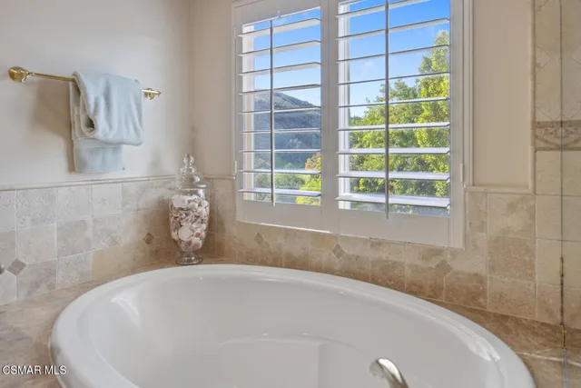 a bathroom with a tub and a window