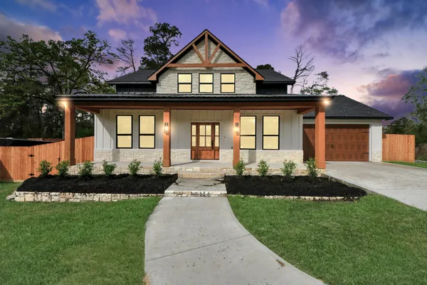a front view of a house with a garden