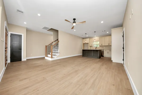 a view of a kitchen with furniture and a ceiling fan