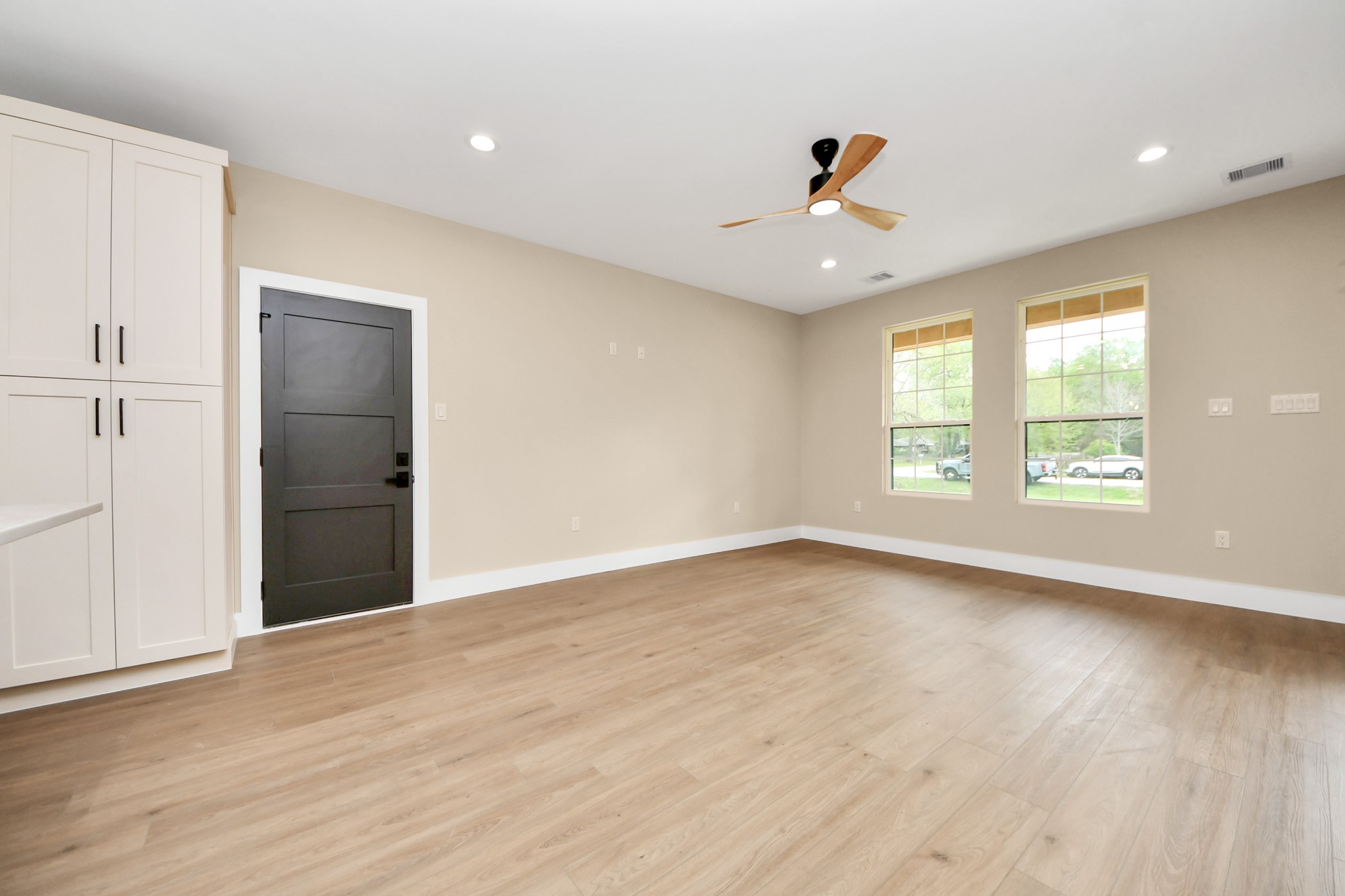 29727 Spring Forest Drive Spring, TX 77386 - Photo 12 of 37 an empty room with wooden floor and windows