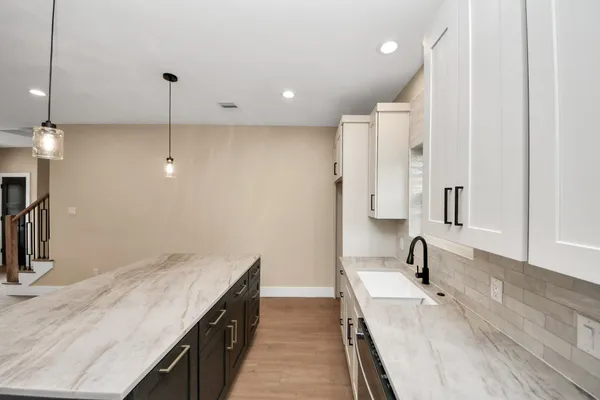 a spacious bathroom with a double vanity sink a mirror and shower