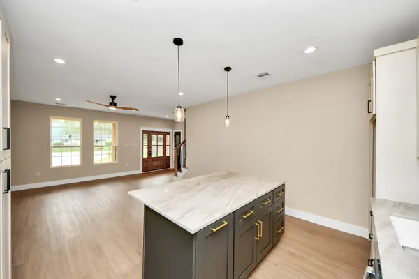 a kitchen with a stove and a wooden floor