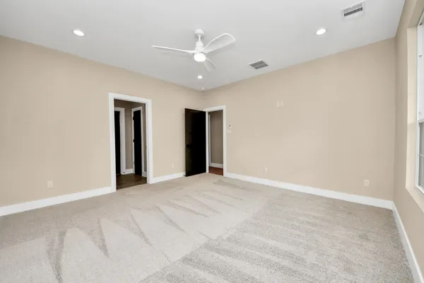 a view of an empty room with a ceiling fan