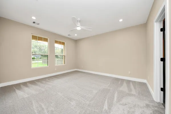 an empty room with windows and closet