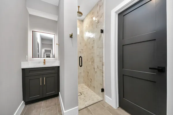 a bathroom with a shower and a sink