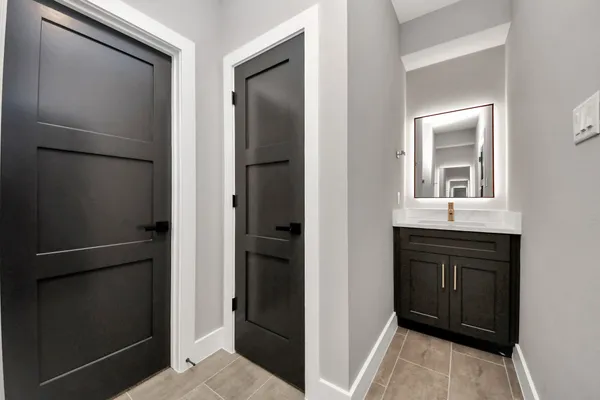 a room with a refrigerator and a sink