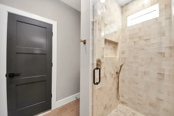 a bathroom with a glass shower door