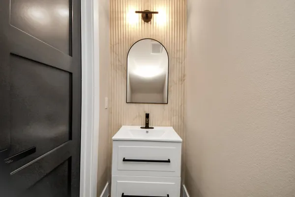 a bathroom with a sink and a mirror