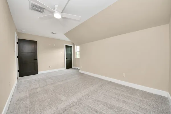 an empty room with a ceiling fan and a ceiling fan