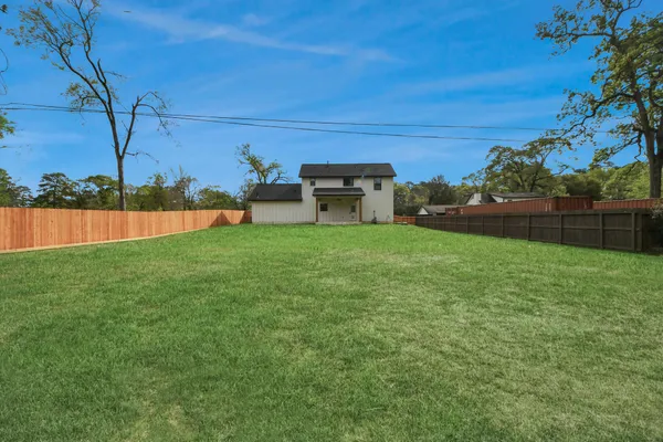 a view of a backyard with sitting area